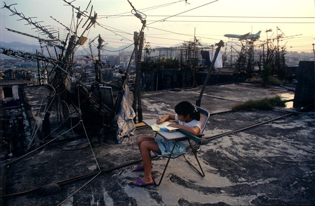 Student doing homework on Walled City rooftop, 1989