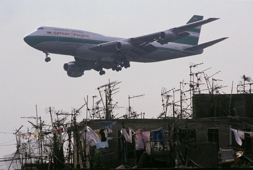Cathay Pacific jet passing Walled City rooftops. 1989