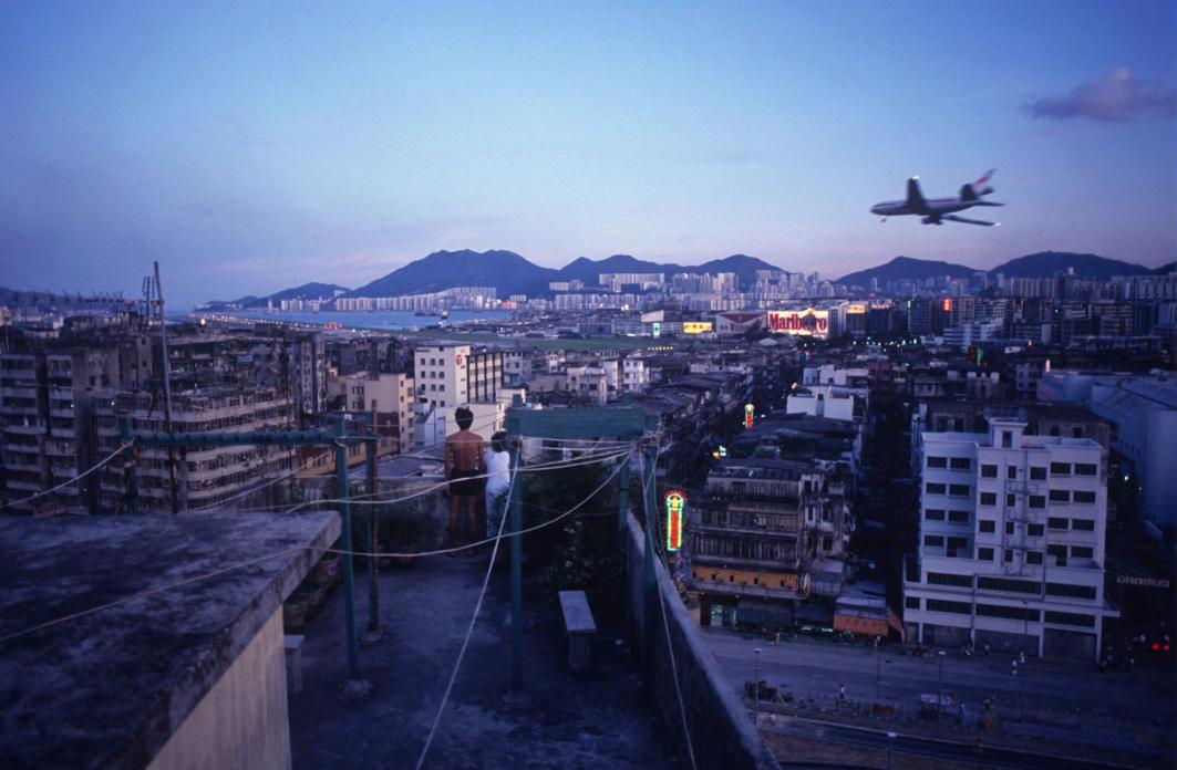 Watching aircraft land at Kai Tak Airport from Walled City rooftop, 1990