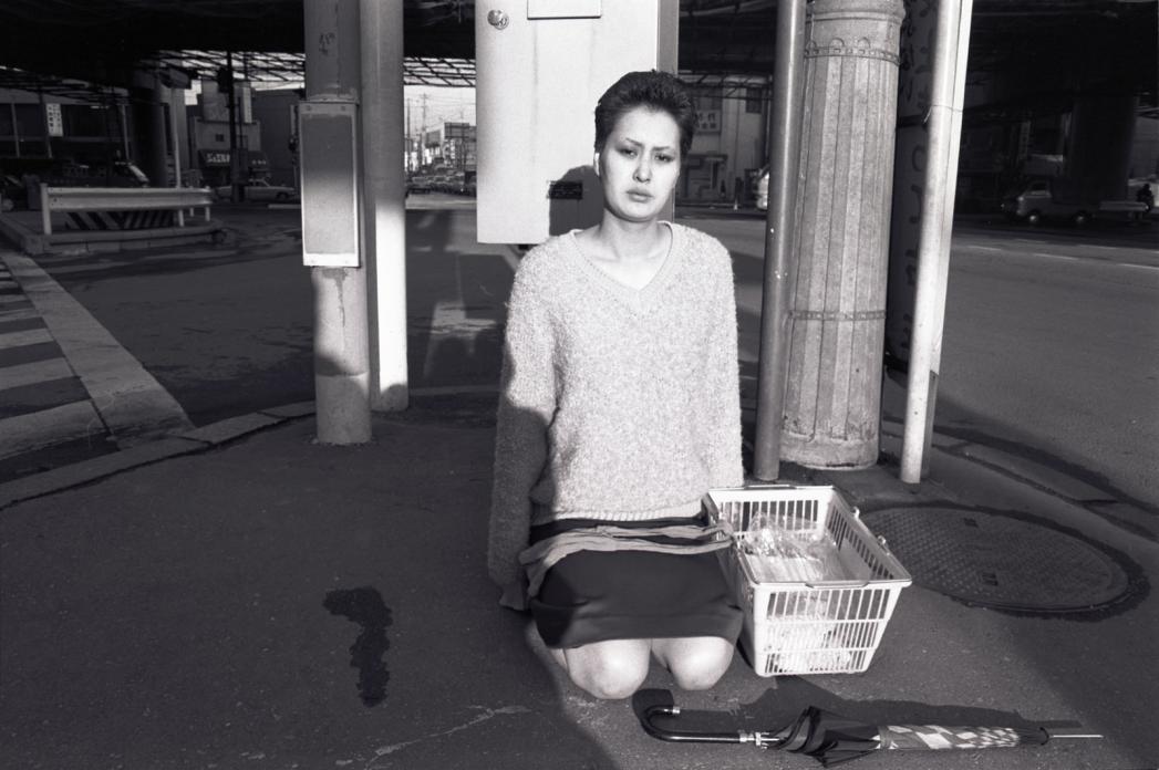 Woman Kneeling in Street. 1980